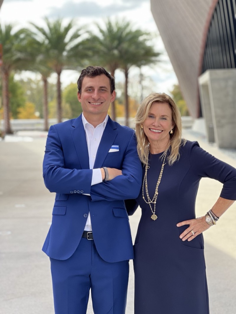Matthew and Chocky Burks in blue suits, a mother-son real estate team in Central Florida